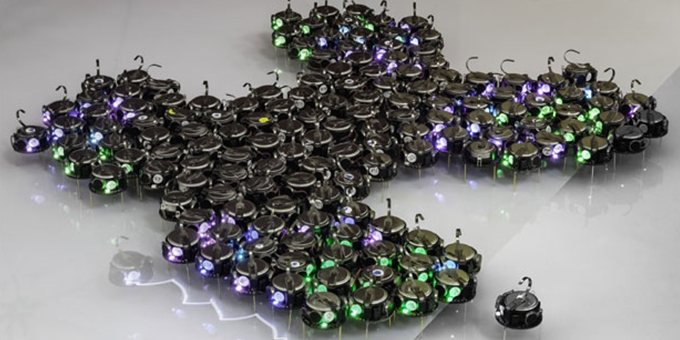 Hundreds of Tiny Robots Grow Bio-inspired Shapes