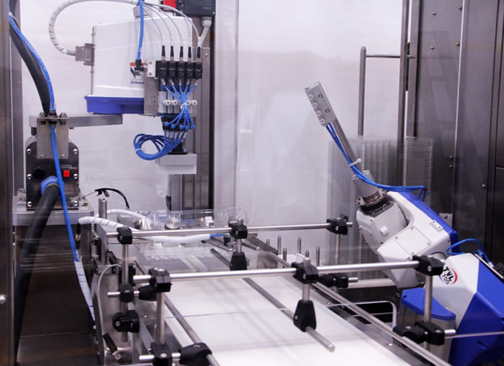 A machine with a robotic armDescription automatically generated with medium confidence
