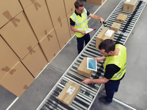 logistics workers in a warehouse in the logistics sector processing packages on the assembly line  - transport and processing of orders in trade